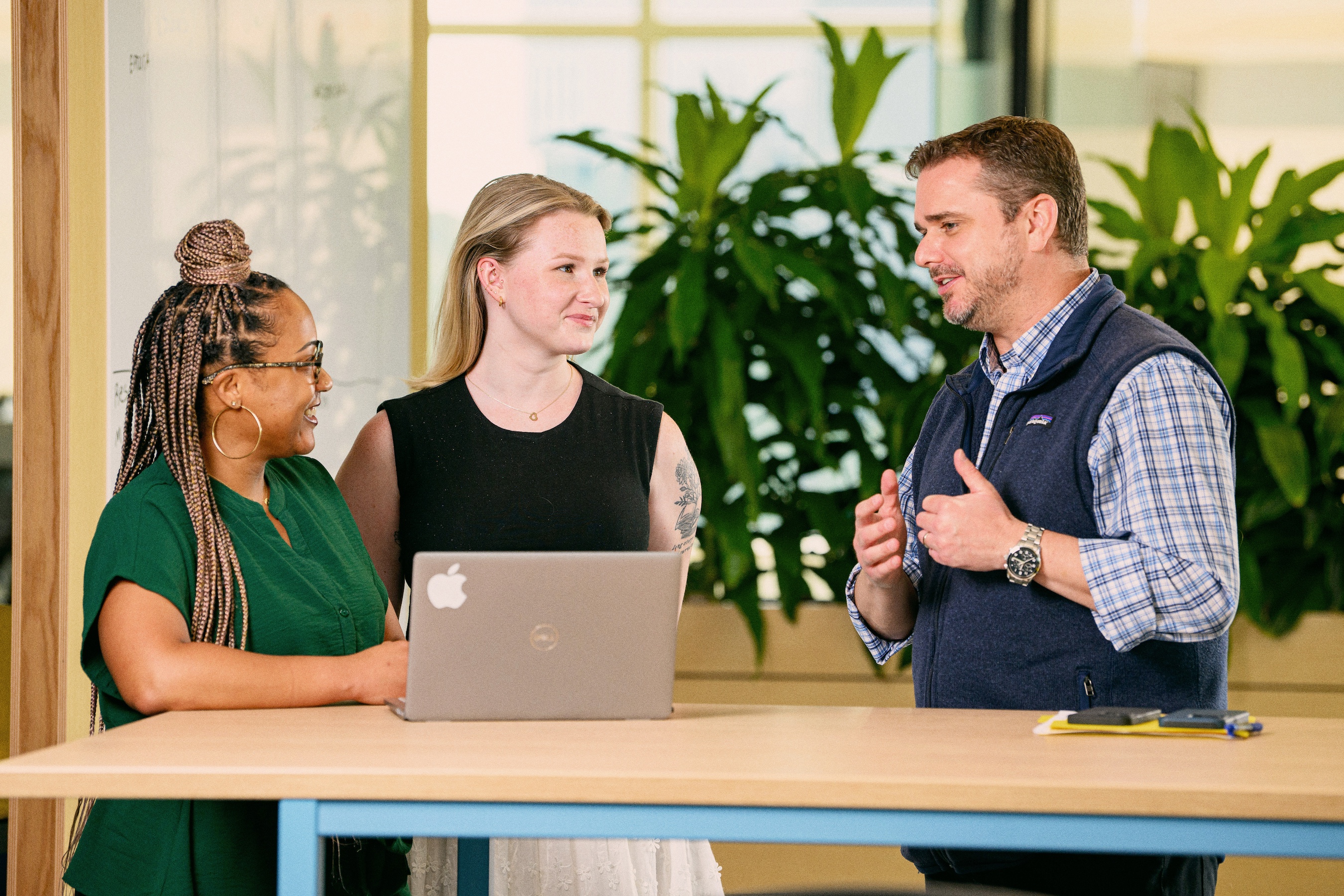 Cox employees collaborating together at a table
