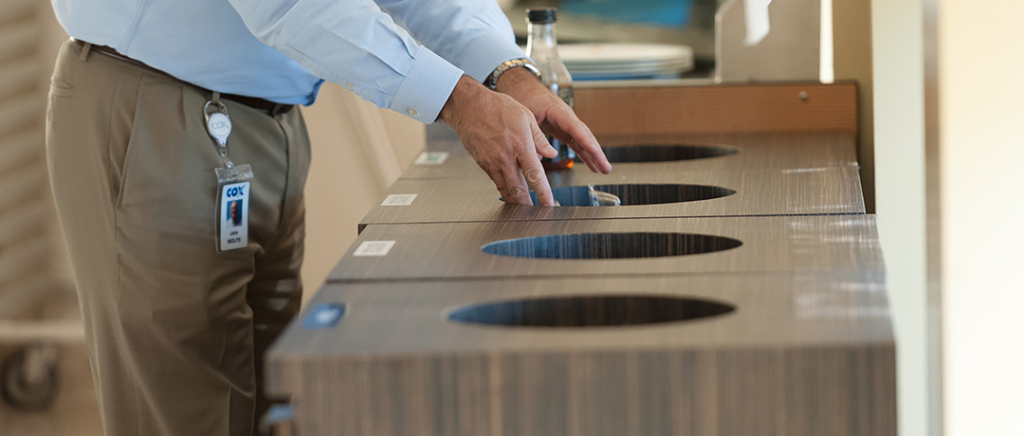 Cox employee placing items in recycling containers