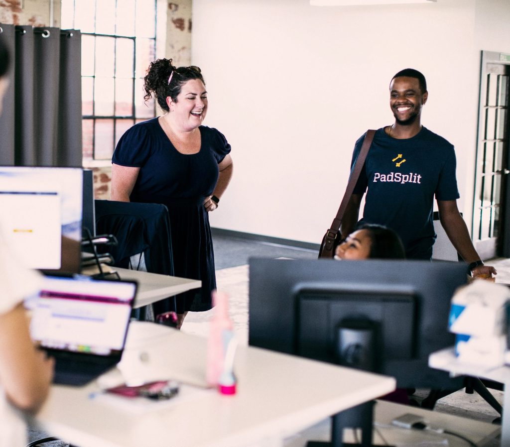 PadSplit employees chatting and laughing at the office
