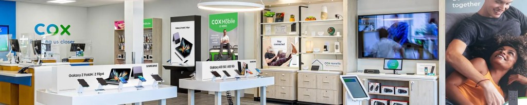 Inside a Cox Store, including display stands and product walls.
