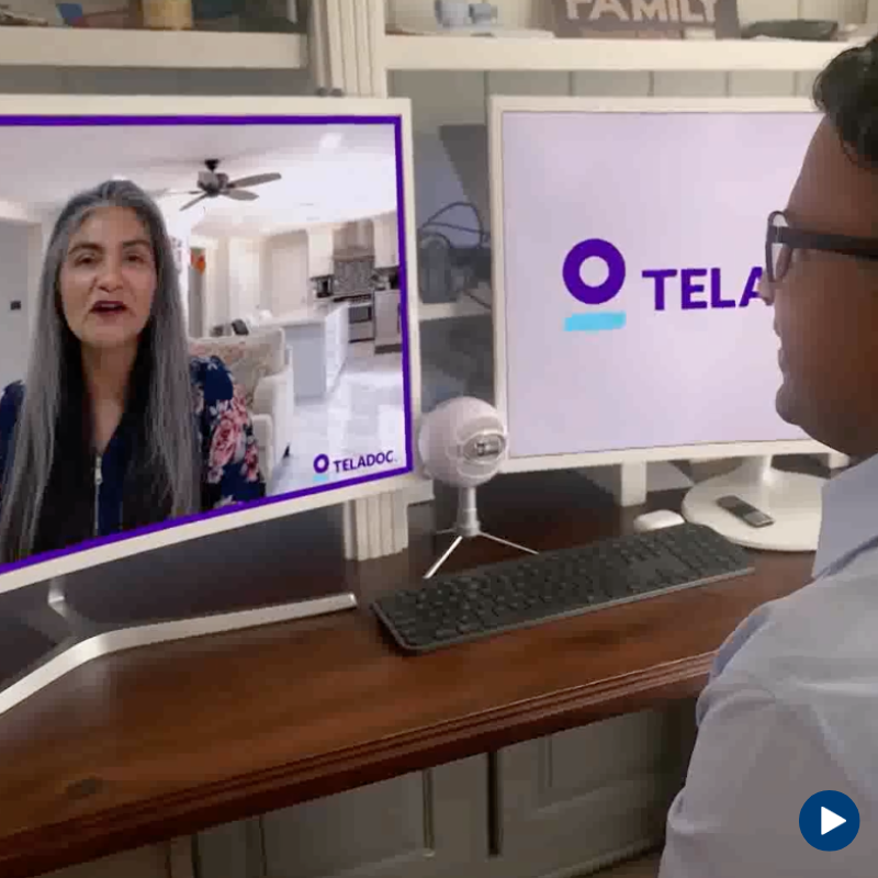 A patient on a telehealth video call with his doctor on his desktop computer