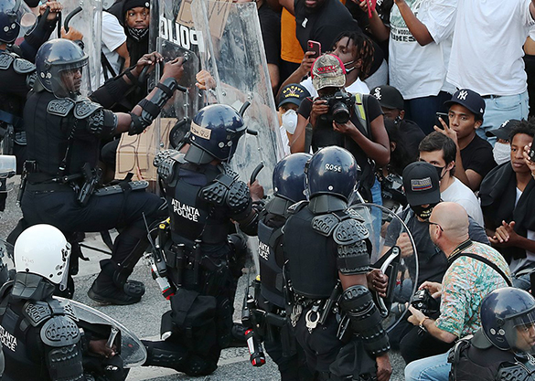 alyssa-covering-protest-in-crowd-has-ball-cap-on.jpg